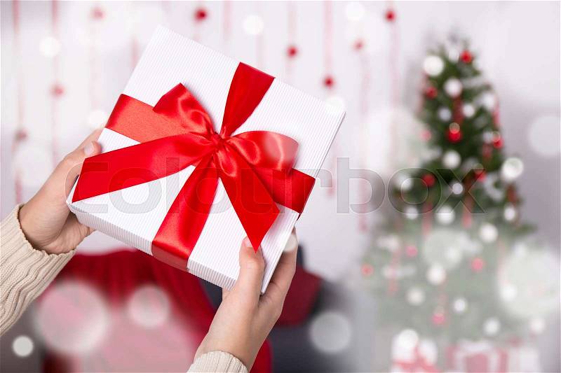 Close up of christmas gift box in male hands, stock photo