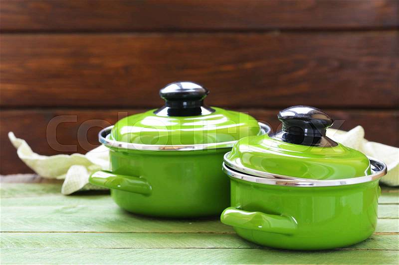 Cooking pot and ingredients for soup or stew on rustic background, stock photo