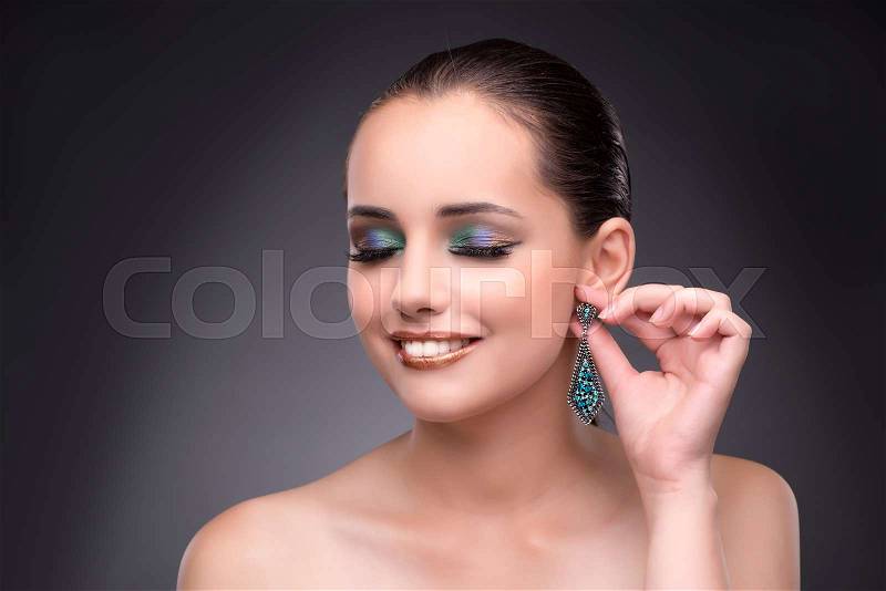 Beautiful woman showing off her jewellery in fashion concept, stock photo