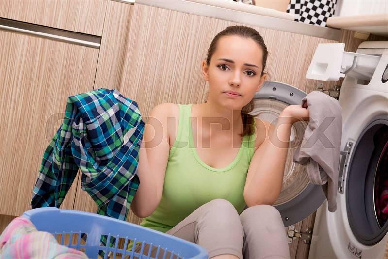 Woman doing laundry at home, stock photo