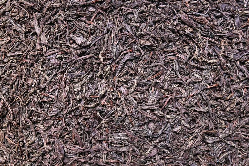 Dried black tea leaves background, texture, stock photo