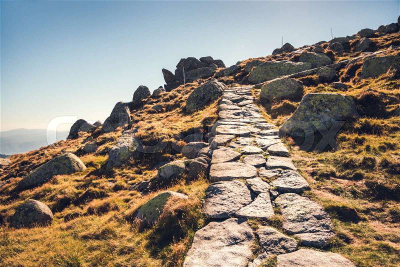 Hiking Path Uphill in Mountains. Many Rocks on the Slope, stock photo