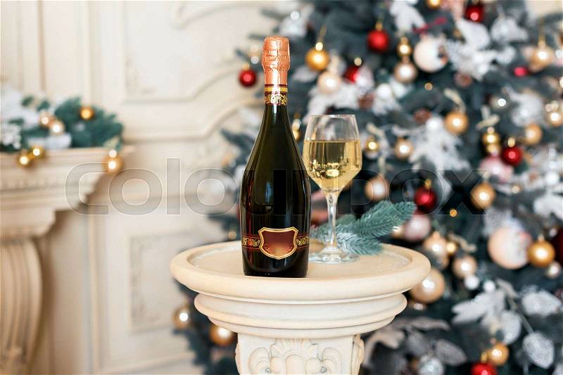 Wine in Christmas setting. New Year decorations. Winter holidays theme, stock photo