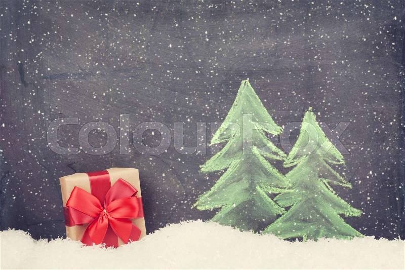 Christmas gift box and hand drawn xmas fir tree with snow. Retro toned, stock photo