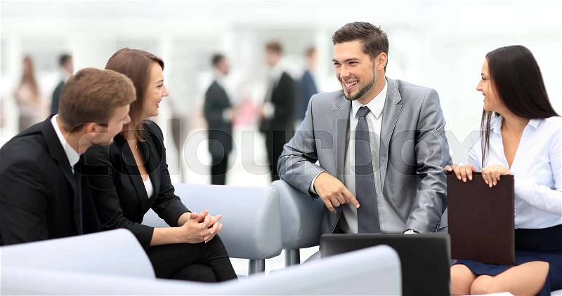 Happy business people talking on meeting at office, stock photo
