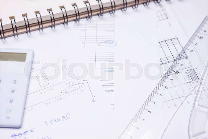 Drawing calculation of business investment project on white papers, stock photo
