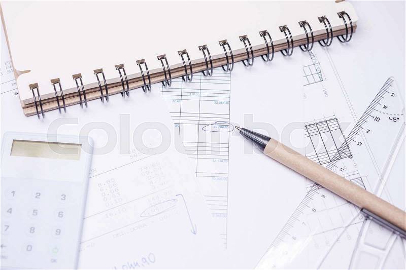 Drawing calculation of business investment project on white papers, stock photo
