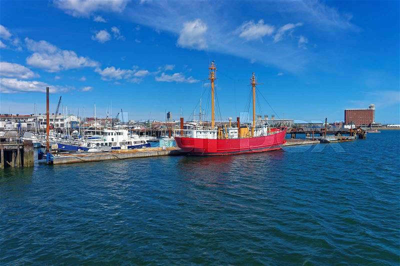Moored red ship near the pier in the Port of Boston in the city of Boston, USA. The port is one of the major seaports in the east coast of USA and in the state Massachusetts, stock photo