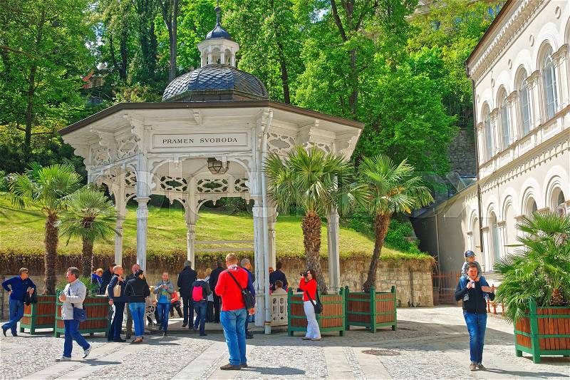 Karlovy vary, Czech republic - May 5, 2014: Freedom Spring at Promenade of Karlovy Vary, Czech republic. People on the background, stock photo