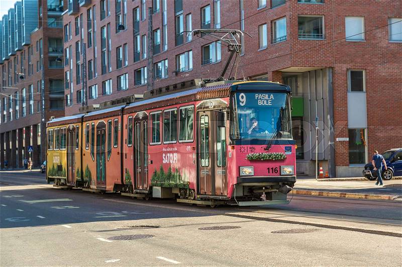 HELSINKI, FINLAND - JUNE 23, 2016: Public transport, modern tram in Helsinki in a beautiful summer day, Finland on June 23, 2016, stock photo