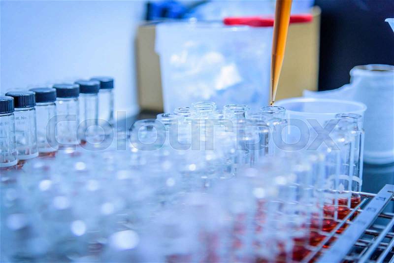 Test tube in scientist hand in laboratory. Selective focus, stock photo