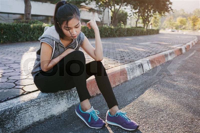 Woman relaxing after sports. Hipster student in the city park, stock photo