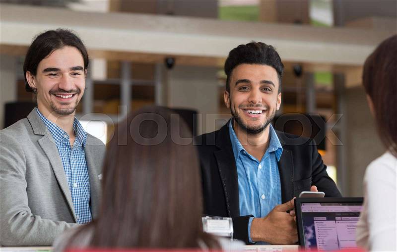 Two Business Man Arrive To Hotel Check In Woman Receptionist Registration At Reception Counter, stock photo