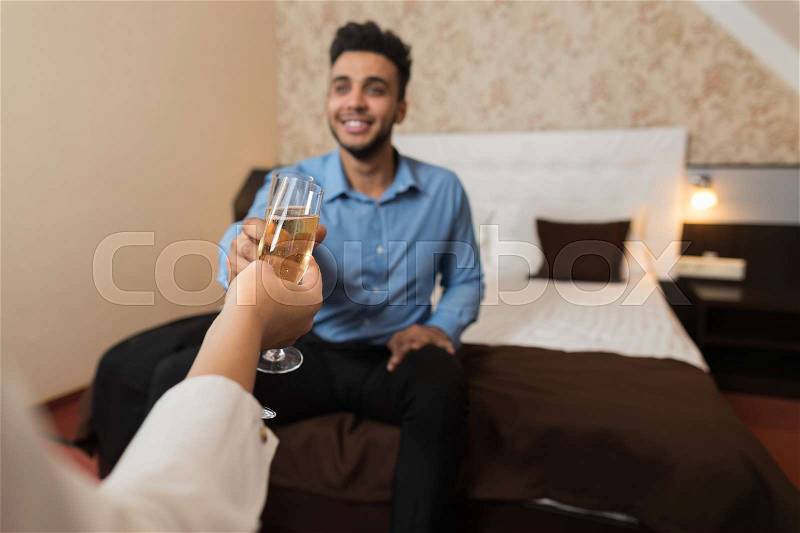 Latin Businessman Clink Champange Glass Cheers Sitting At Bed Room With Businesswoman Business Man Woman Lovers Hotel, stock photo
