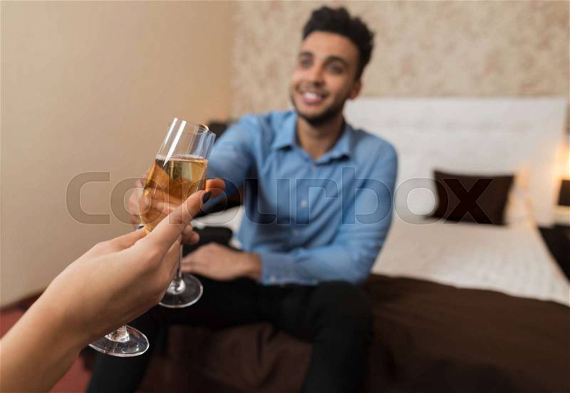 Latin Businessman Clink Champange Glass Cheers Sitting At Bed Room With Businesswoman Business Man Woman Lovers Hotel, stock photo