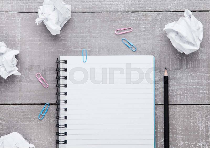 Blank writing pad with pencil for ideas on wooden background, stock photo
