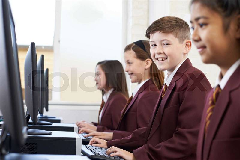 Pupils Wearing School Uniform In Computer Class , stock photo