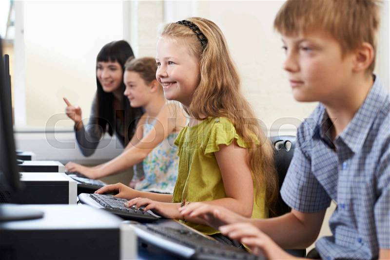 Elementary Pupils In Computer Class With Teacher, stock photo