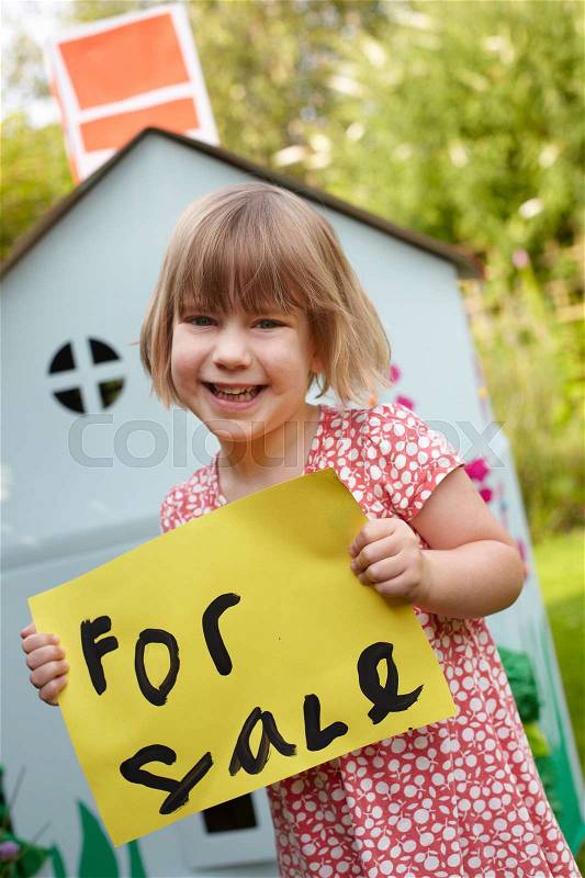 Little Girl Holding For Sale Sign Outside Play House, stock photo