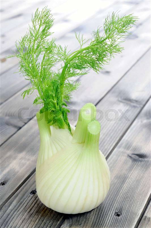Fresh fennel organic production, photographed on wooden table, stock photo