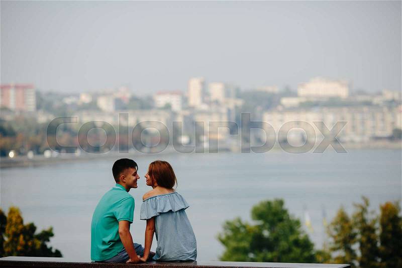 Man and woman together on a background of lake, stock photo