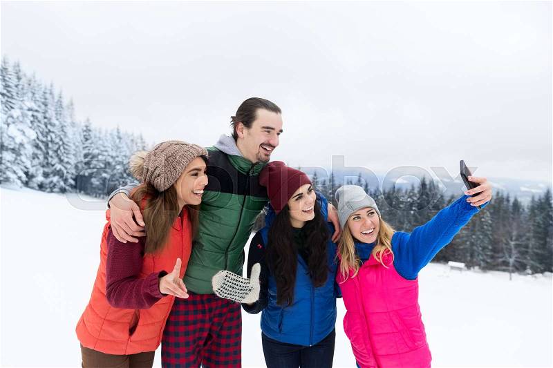 Woman Hold Smart Phone Camera Taking Selfie Photo Friends Smile Snow Forest Young People Group Outdoor Winter Mountain Woods, stock photo