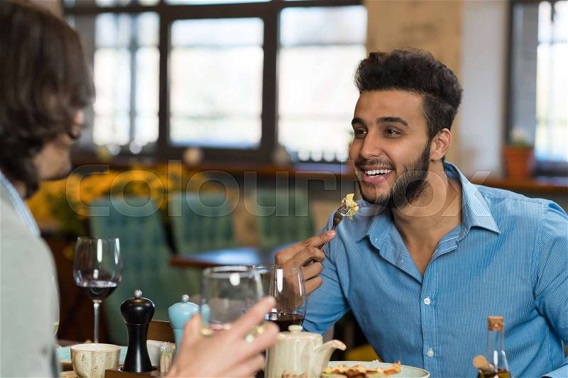 Young Business Man Restaurant Table, Friends Eating Drink Wine Smiling Mix Race Men Women, stock photo