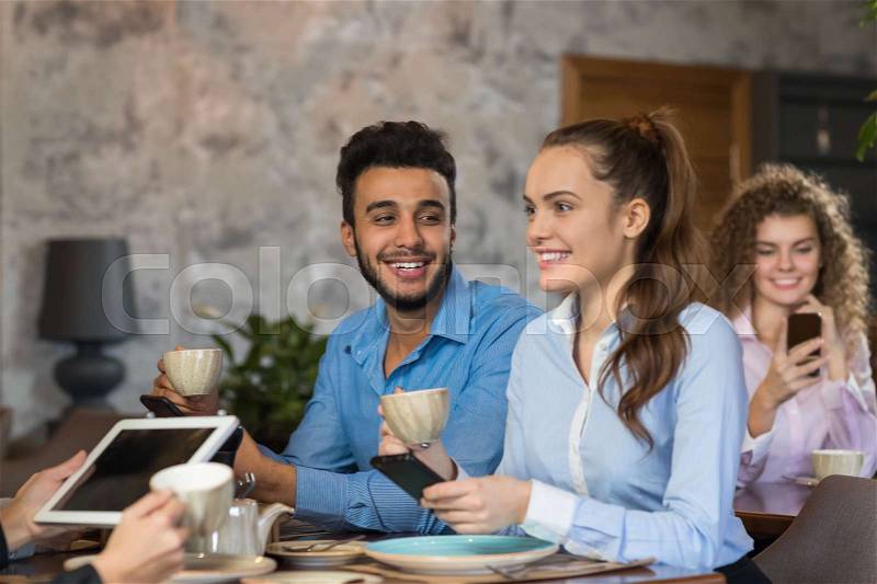 Young Business People Group Drink Coffee Sitting Cafe Table, Friends Hold Cup Smiling Mix Race Men Women Talking, stock photo