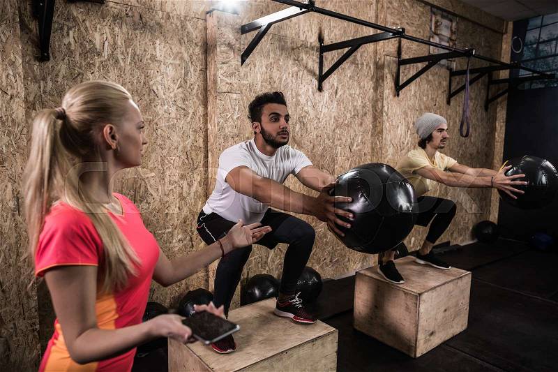 Sport Fitness People Group Crossfit Training Equipment, Young Healthy Man And Woman Gym Interior Doing Exercises, stock photo