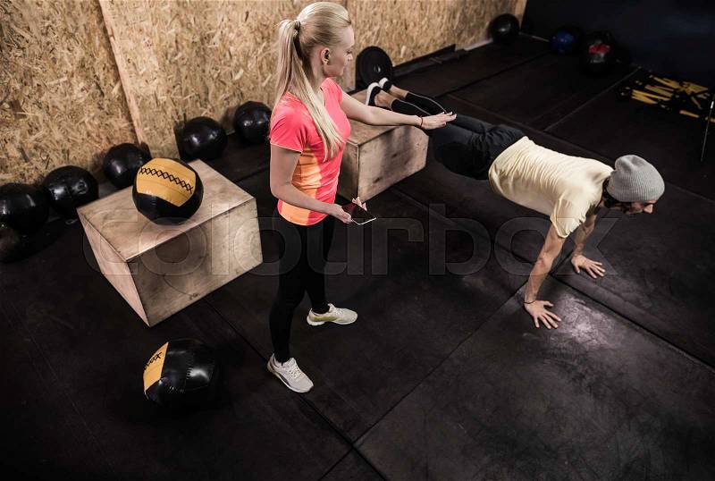 Sport Fitness People Crossfit Training, Young Healthy Man Do Push Ups Woman Trainer Gym Interior, stock photo