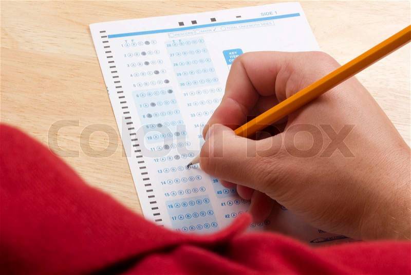 Over the shoulder photograph of a student taking a test, stock photo