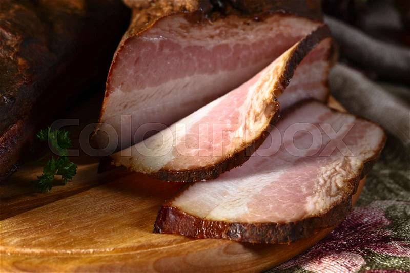 Smoked meat with spices on kitchen table, stock photo