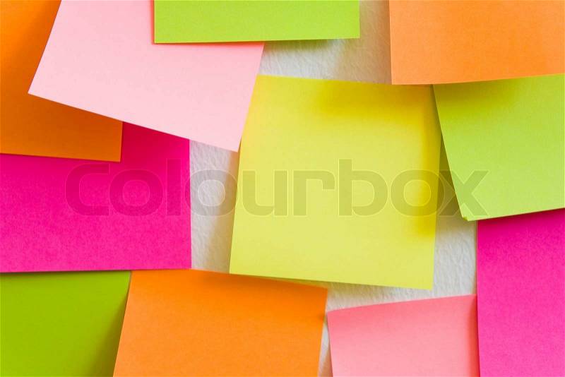 Blank sticky notes attached to a white wall, stock photo