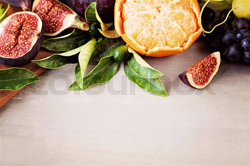 Fruit Border of Grape, Tangerines, Figs on Wooden Background. Healthy Eating, stock photo