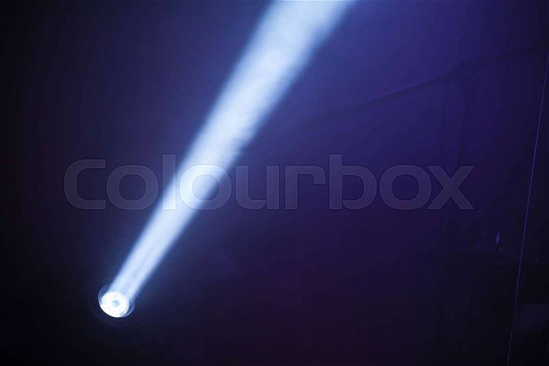 Ray of scenic LED spot light over dark foggy background, stage illumination equipment, stock photo