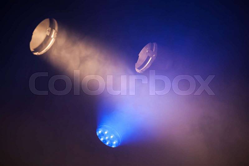 Colorful tungsten and LED spot lights with strong beams in the dark, stage illumination background photo, stock photo