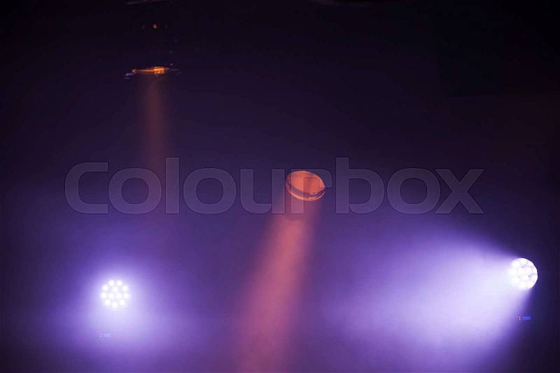 Colorful spot lights with strong beams in dark fog, stage illumination background photo, stock photo