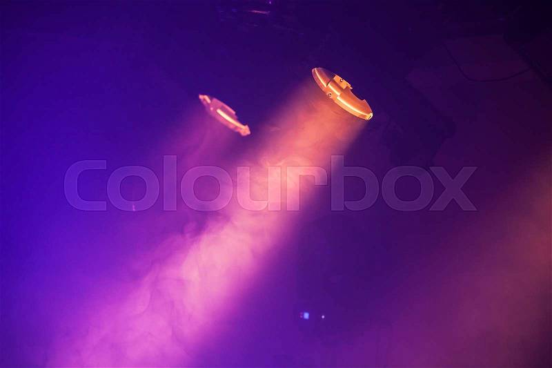 Spot lights with purple rays in the dark, stage illumination equipment, stock photo