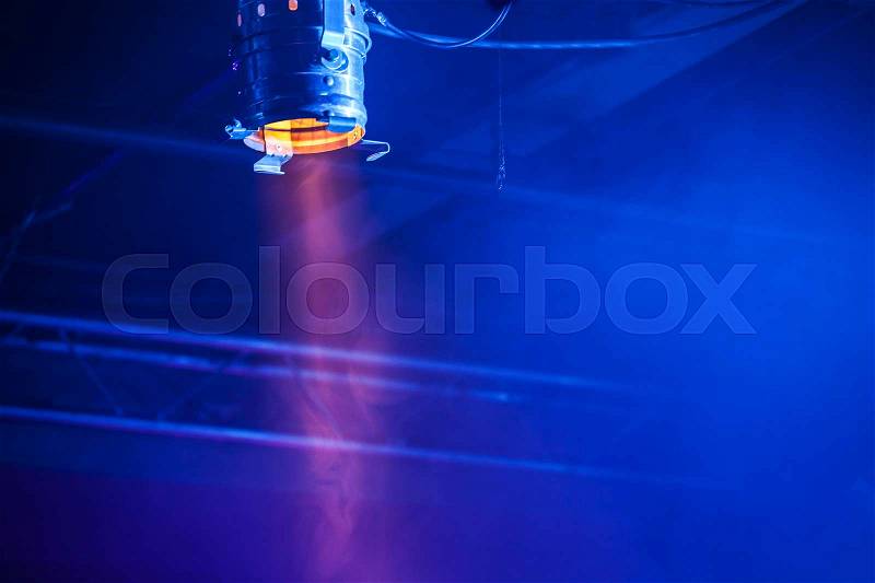 Bright classical spot light over dark blue background, stage illumination equipment, stock photo
