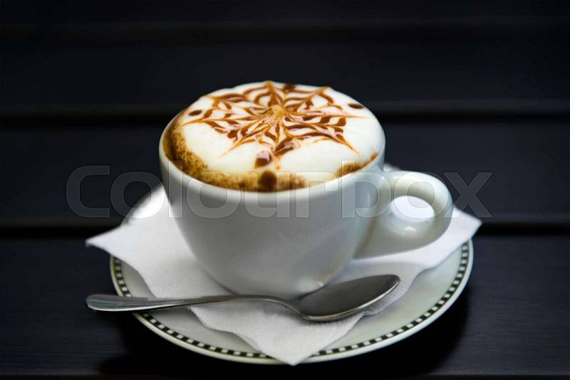 Cup of cappuccino, cup of coffee, cup of coffee on black wooden table, stock photo