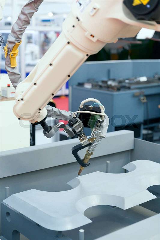Industrial welding robotic arm, stock photo