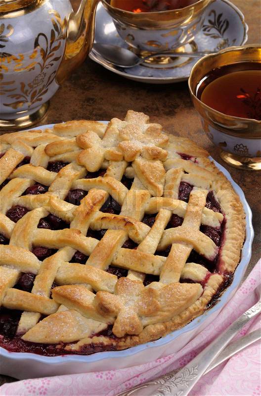 Cherry pie dough with decorative ornaments in roasting pan, stock photo