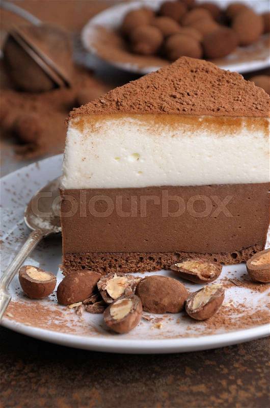 A piece of chocolate with vanilla mousse cake covered cocoa, stock photo