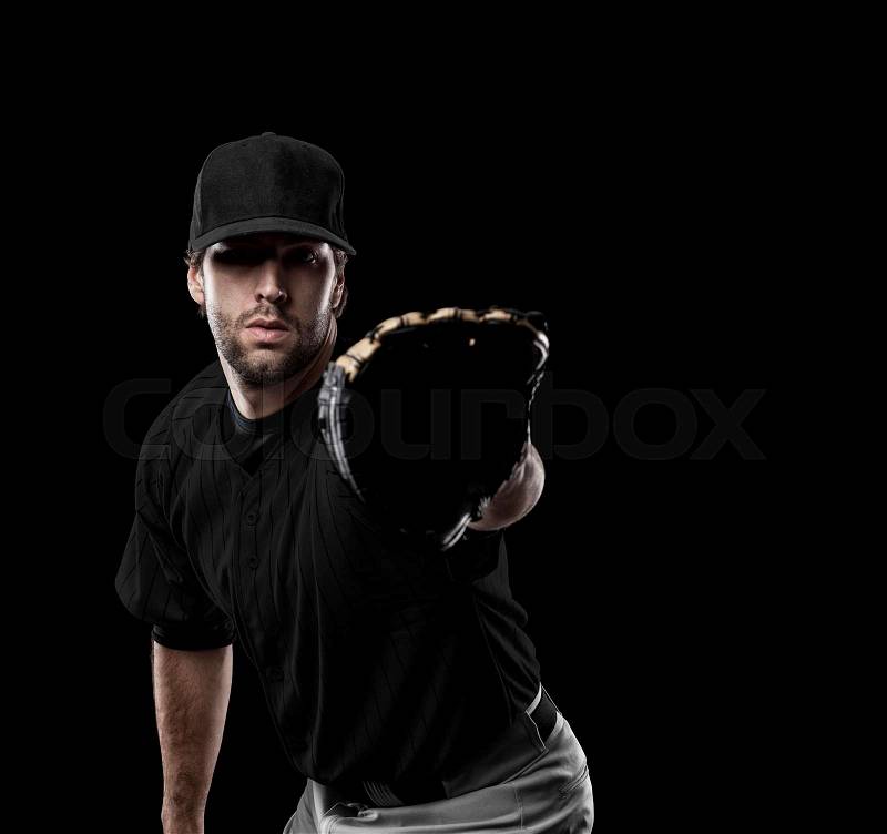 Baseball Player with a black uniform on a black background, stock photo