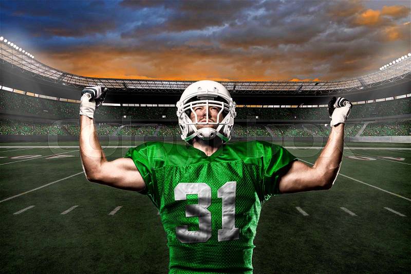 Football Player with a green uniform celebrating with the fans, stock photo