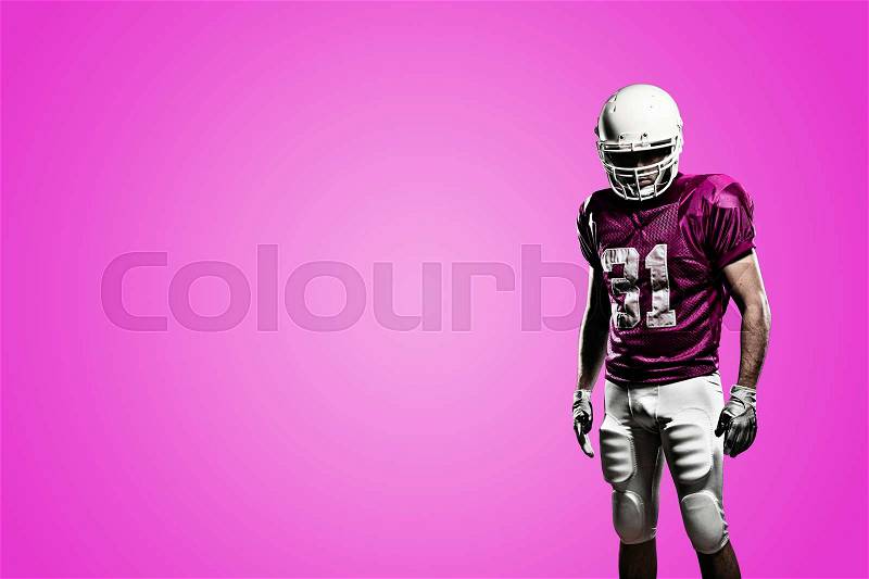 Football Player on a pink uniform, on a pink background, stock photo