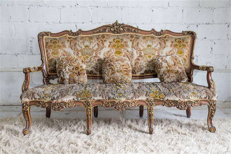 Brown vintage sofa on white wall, stock photo