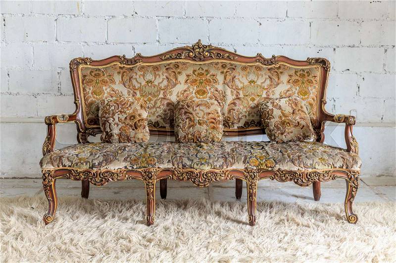 Brown armchair sofa on white wall, stock photo