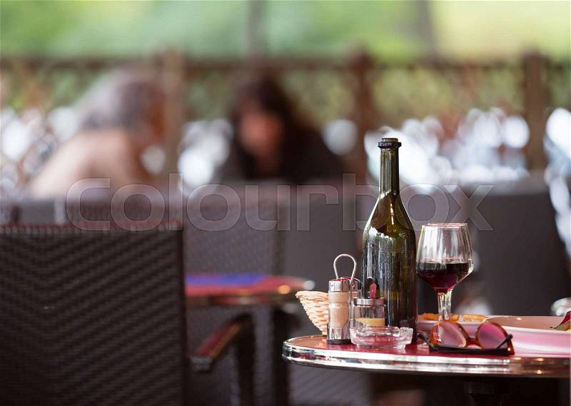Carafe of red wine with two glasses on the table with dinner dishes, stock photo