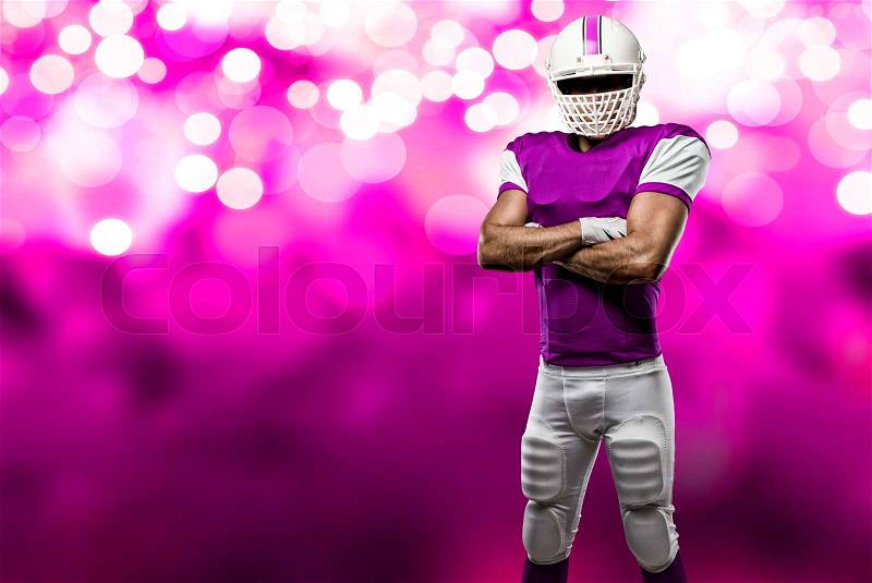 Football Player with a pink uniform on a pink lights background, stock photo